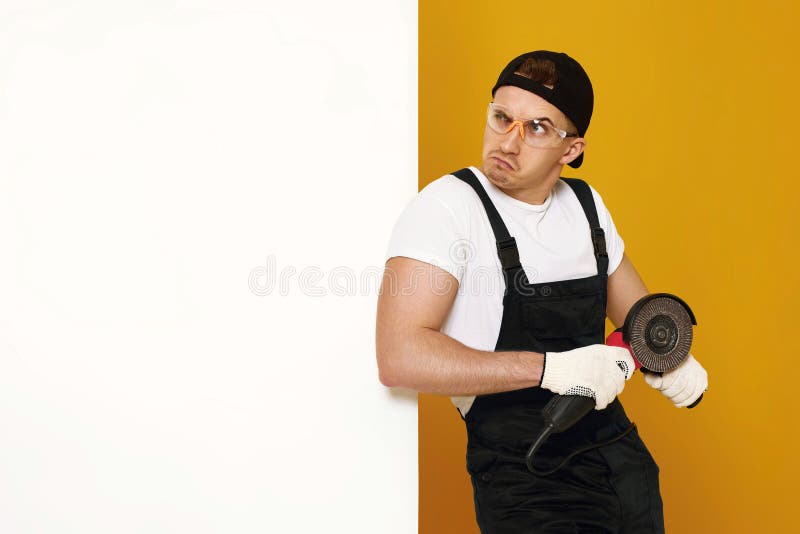 professional builder in work clothes works with cutting tool. royalty free stock photos