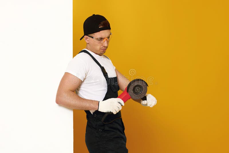 professional builder in work clothes works with cutting tool. royalty free stock photo