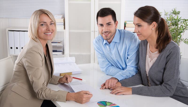 Professional business meeting: young couple as customers and an stock images Professional business meeting: young couple as customers and an stock images