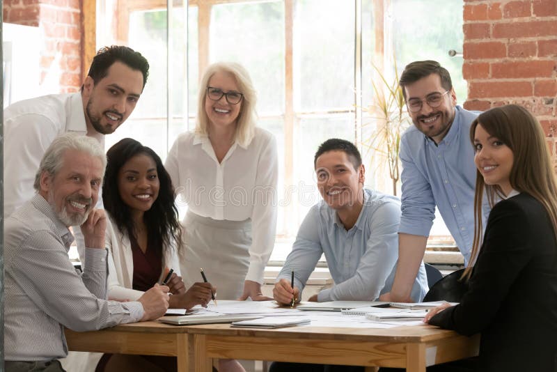 Professional business team young and old people posing at table