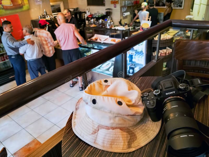 Montreal, Canada. Jul 2019. The unequaled Sony a9 professional mirroless camera with standard zoom resting on a restaurant table while photographer takes a lunch break. Montreal, Canada. Jul 2019. The unequaled Sony a9 professional mirroless camera with standard zoom resting on a restaurant table while photographer takes a lunch break