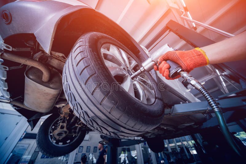 professional-car-mechanic-working-with-pneumatic-wrench-in-auto-repair-service-stock-image