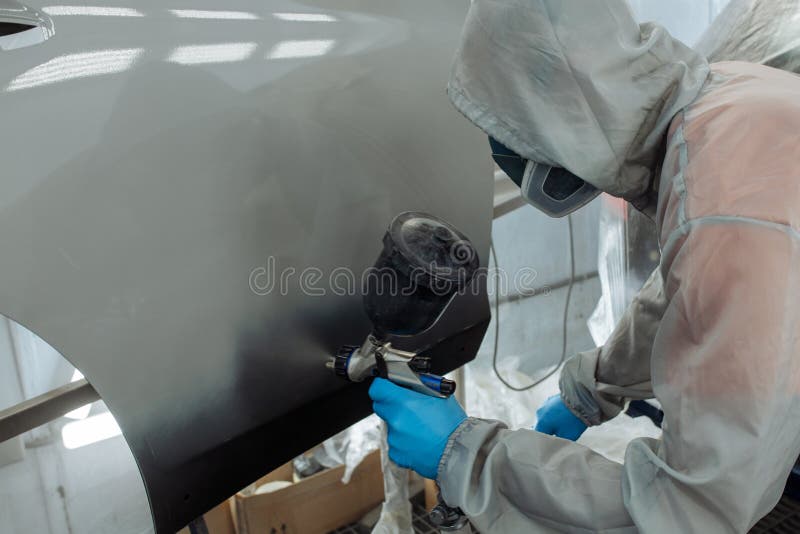 Professional Car Painter is Painting in Garage by Airbrush. Stock Image