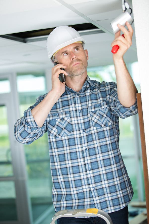 Technician Installing Cctv Camera on Ceiling Indoors Stock Image