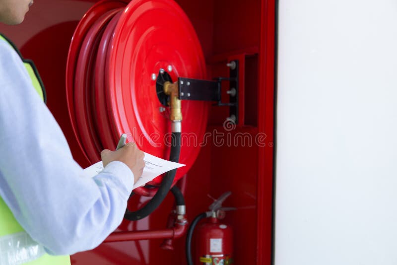 A Professional checking aFire extinguisher