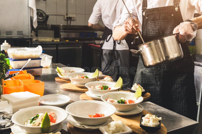 Professional Chef Cooking In The Kitchen Restaurant At The Hotel