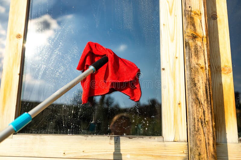 Hand washing and cleaning window with professionally squeegee portable  vacuum cleaner. Maid cleans window Stock Photo - Alamy