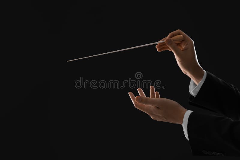 Professional Conductor with Baton on Black Background, Closeup. Space