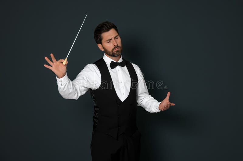 Professional Conductor with Baton on Grey Background Stock Image