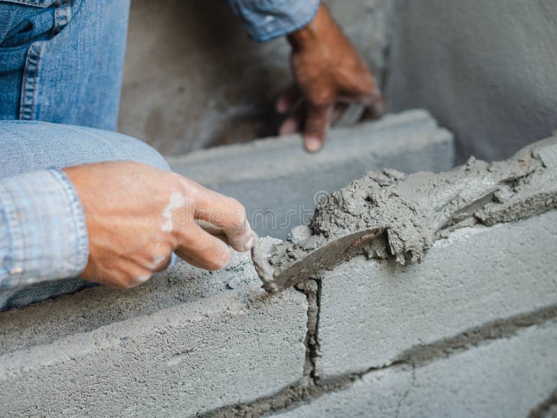 Professional construction worker laying bricks with cement royalty free stock photos Professional construction worker laying bricks with cement royalty free stock photos