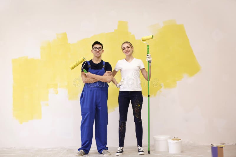 Professional decorators with paint rollers indoors stock images Professional decorators with paint rollers indoors stock images