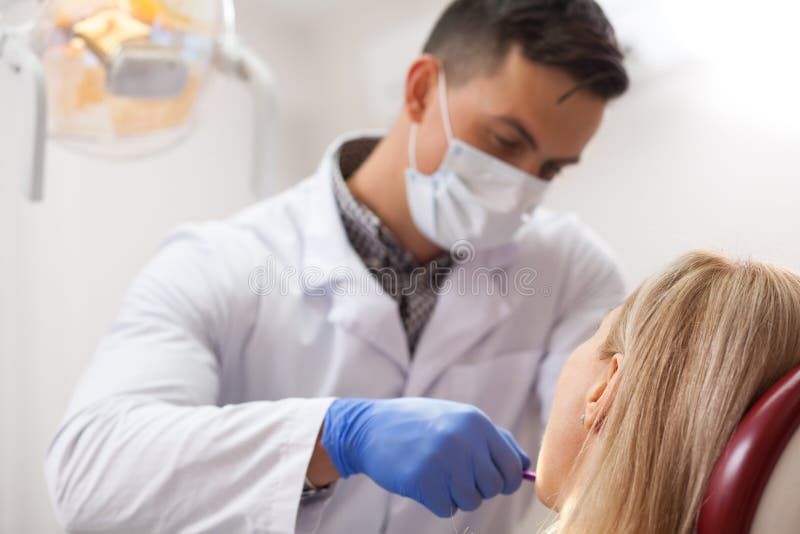 Mature woman visiting dentist at the clinic stock images Mature woman visiting dentist at the clinic stock images