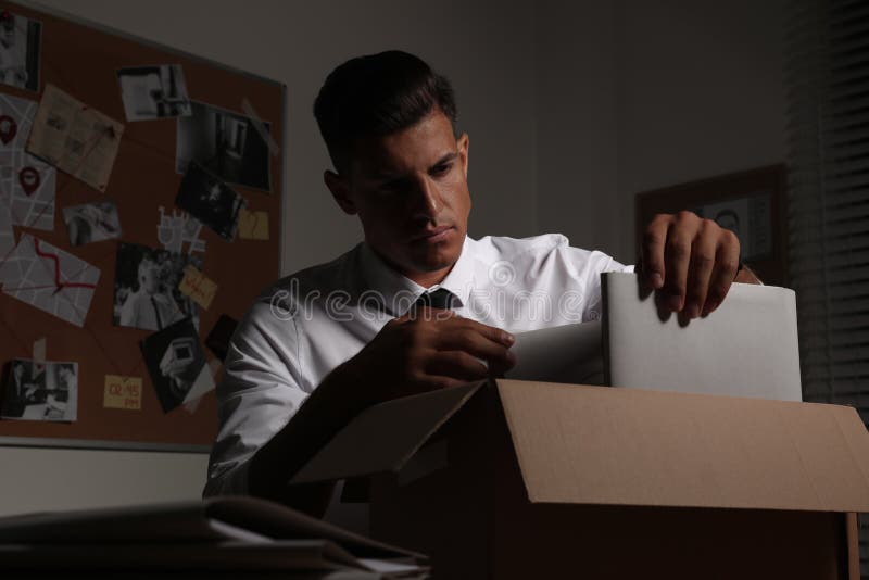 Professional detective doing paperwork in his office. Detective paperwork stock images, royalty-free photos and pictures