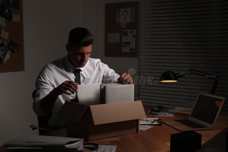Professional detective doing paperwork in his office. Detective paperwork stock images, royalty-free photos and pictures