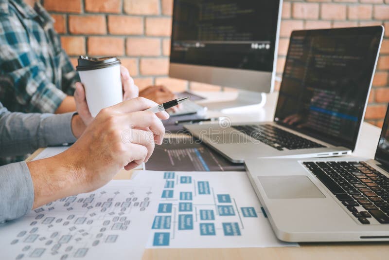 Professional Developer programmer cooperation meeting and brainstorming and programming in website working a software outsourcing and coding technology, writing codes and database. Program coding working stock images, royalty-free photos and pictures