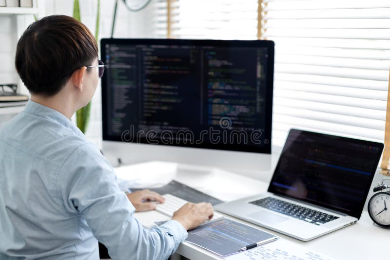 Professional development programmers are sit on a desk with work equipment royalty free stock image