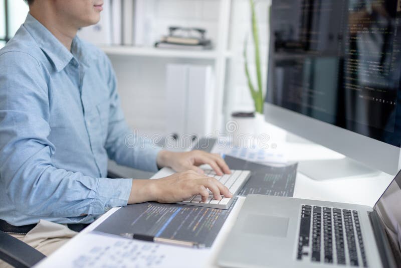 Professional development programmers are sit on a desk with work equipment stock images