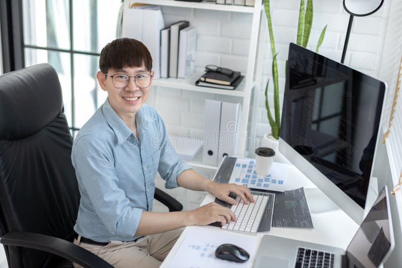 Professional development programmers are sit on a desk with work equipment stock photos