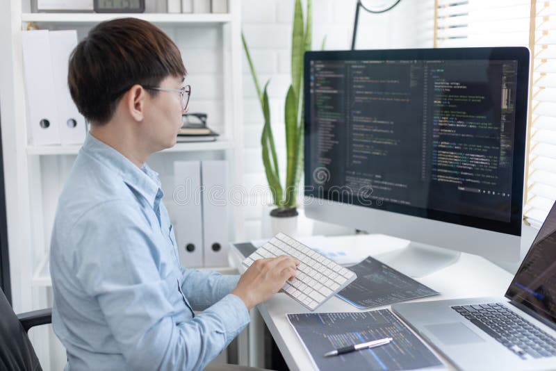 Professional development programmers are sit on a desk with work equipment royalty free stock photos