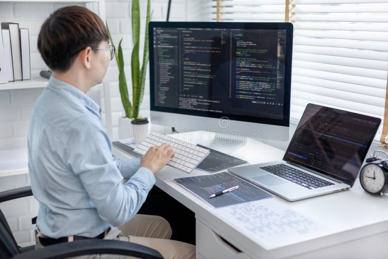 Professional development programmers are sit on a desk with work equipment royalty free stock images