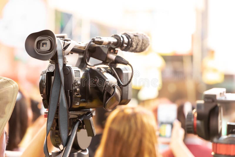 Professional Videographer Holding Camera Mounted On Easy Rig. Videographer Using Steadicam. Pro
