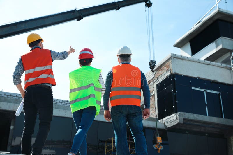 Professional Engineers in Safety Equipment at Construction Site Stock