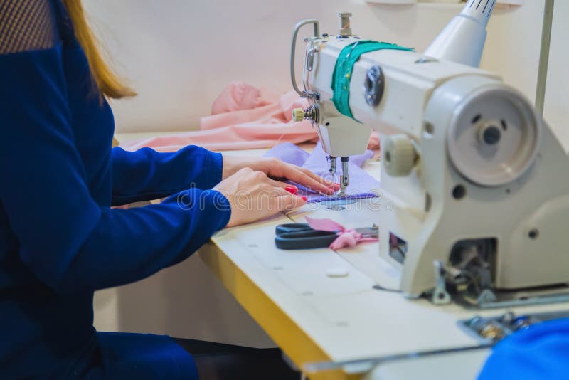 Professional Fashion Designer Using Sewing Machine at Atelier Stock