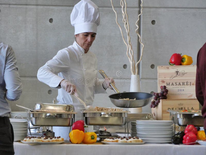 Professional female chef prepares buffet food for customers royalty free stock photo Professional female chef prepares buffet food for customers royalty free stock photo