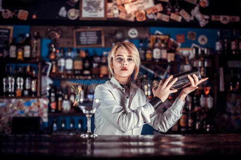 Professional Girl Bartending Adds Ingredients To a Cocktail in the Bar ...