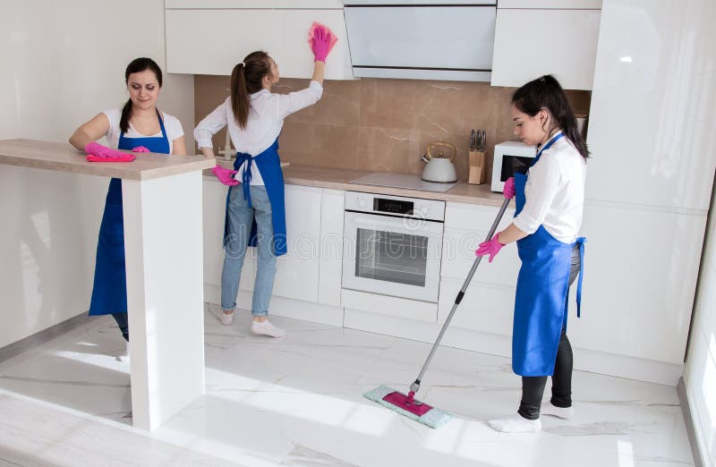 Professional House Cleaning. Three Beautiful Girls are Cleaning the