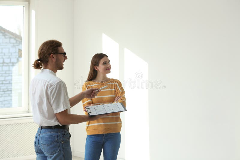 Professional Interior Designer Consulting Woman in Apartment. Space for