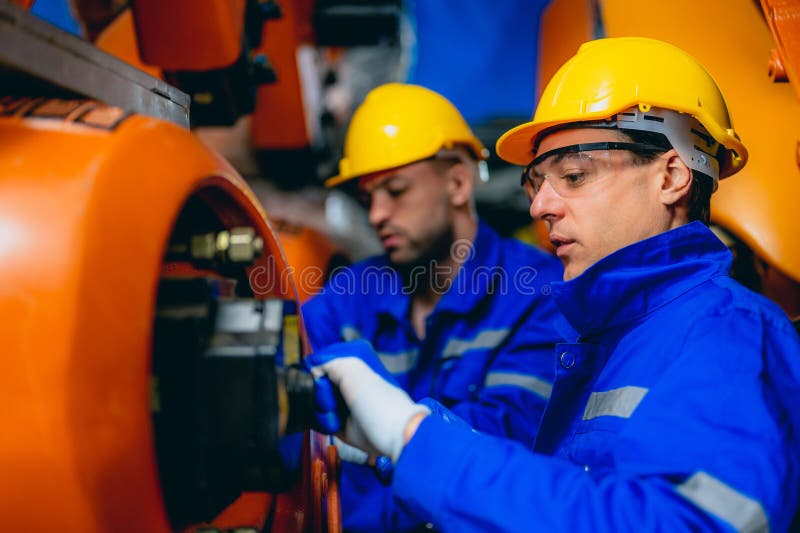 Professional Maintenance Worker with Machine Robotic Arms at Industrial