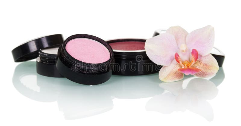 Professional makeup: eye shadow, blush and orchid flower isolated.