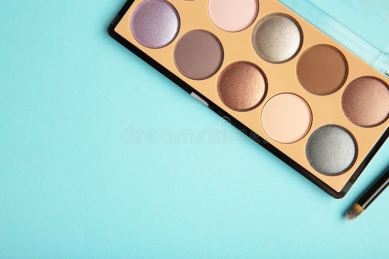 Professional Makeup Palette with Brush on Blue Background Stock Photo