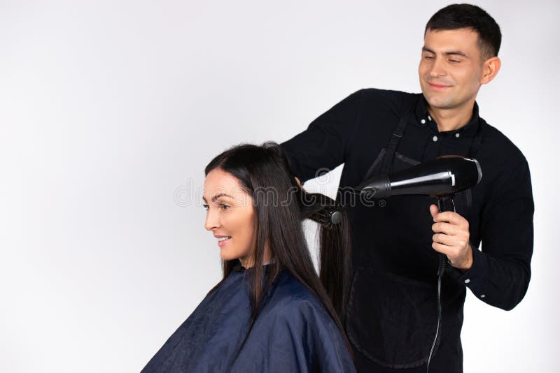 A Professional Male Hairdresser Dries a Young Woman`s Hair with a Foen.  Gender Stereotypes Stock Image - Image of female, inclusivity: 204492647