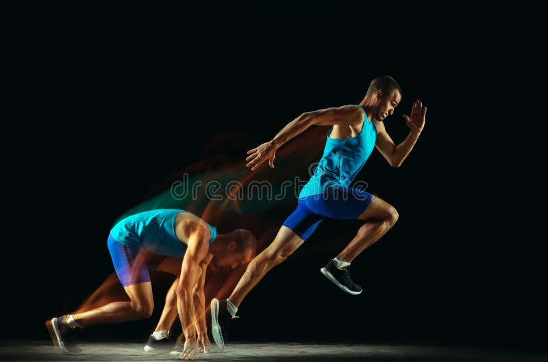Professional male runner training isolated on black studio background in mixed light. Man in sportsuit practicing in run or jogging. Healthy lifestyle, sport royalty free stock image Professional male runner training isolated on black studio background in mixed light. Man in sportsuit practicing in run or jogging. Healthy lifestyle, sport royalty free stock image