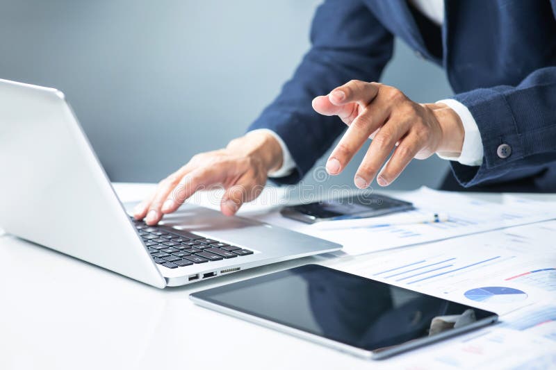 Professional man using computer laptop at modern workspace. Entrepreneur working proactive. Data analysis and strategy plan for royalty free stock photo