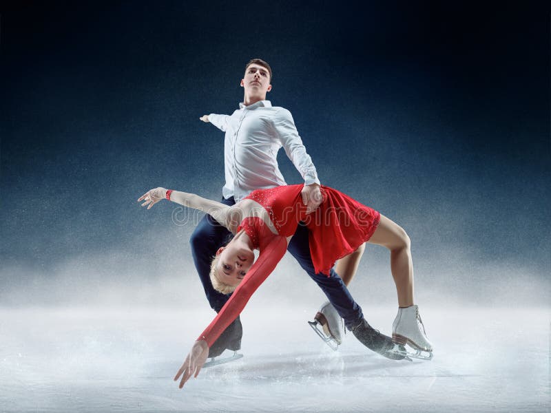 Professional men and women figure skaters performing show or competition on ice arena. Professional men and women figure skaters performing show or competition on ice arena