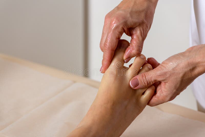 Professional Massage Therapist Working On A Woman Hand And Foot Stock