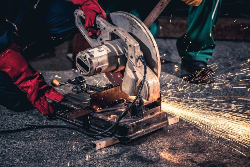 Professional Mechanic Man is Cutting Steel Metal with Rotating Carbon