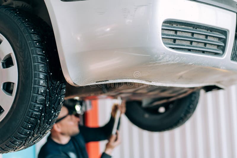 Professional Mechanic Repairs an Internal Combustion Engine and Changes