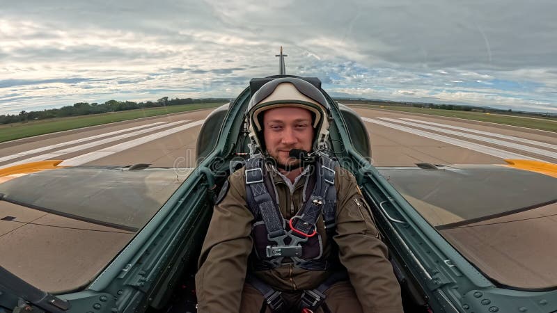 Professional military pilot sitting in the fighter jet cockpit before flight, confident man aviator looking at camera on stock video footage