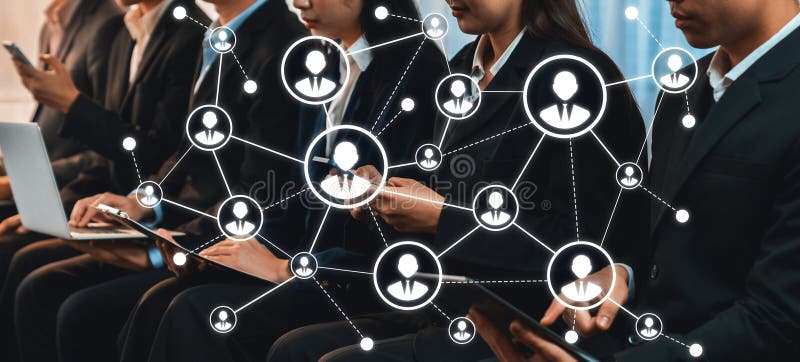 Dynamic scene of professionals engaging in networking at an event, utilizing digital devices to connect and collaborate in a modern business setting, showcasing interaction and technology. Amity. Networking profiles stock images, royalty-free photos and pictures