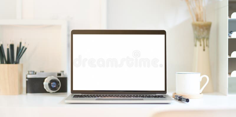 Professional photographer`s workplace with open blank screen laptop