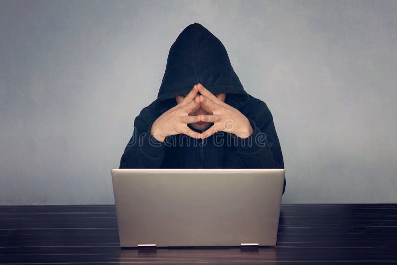 Professional programmer thinking how to design developing online steal system through code language and hacking identity information, thoughtful hacker in a black hood, picks up the password. Developing programmer stock images, royalty-free photos and pictures