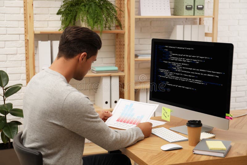 Professional programmer working with computer stock images