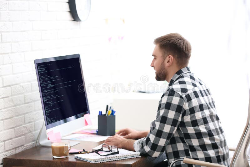 Programmer working with computer in office stock images