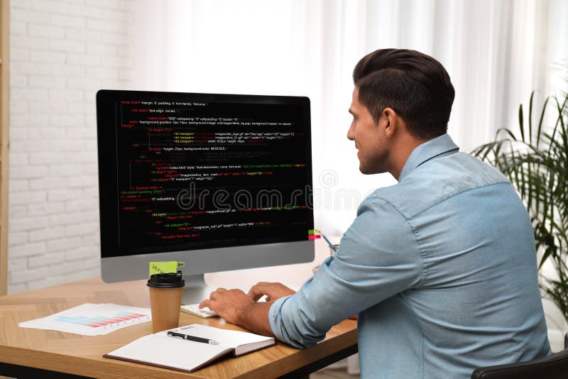 Professional programmer working with computer stock photo