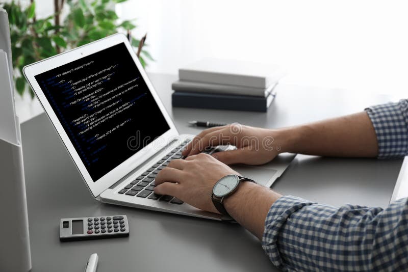 Professional programmer working with laptop in office stock photo