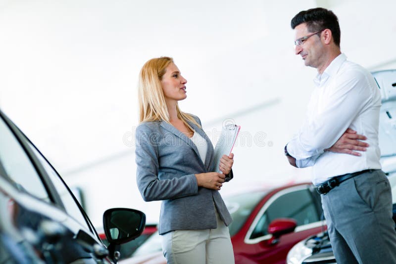 Professional Salesperson Selling Cars At Dealership To Buyer Stock